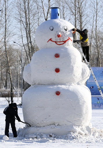 Men work on a 5 meters high snowman at a park in a Siberian city of Krasnoyarsk
