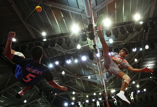 Thailand's Pornchai Kaokaew blocks a shot by Singapore's Muhammad A'Fif Safiee during their men's team sepak takraw preliminary round match at SEA Games in Singapore