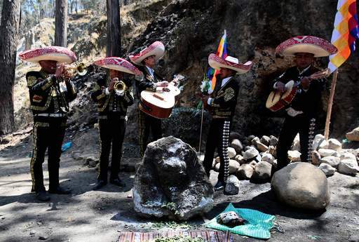 A Mariachi group performs in honor of a stone which bears an impression that locals refer to as Devil face, as a shrine frequented by indigenous witch doctors was removed to expand a main highway between La Paz and El Alto