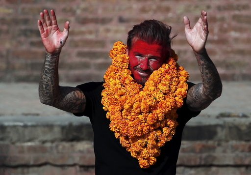 David Beckham waves toward his fans while on his way back after playing a charity match to collect funds for UNICEF at the ancient city of Bhaktapur