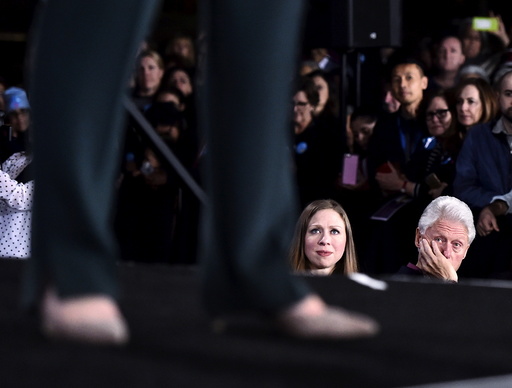 Chelsea Clinton and her father, former President Bill Clinton look on as U.S. Democratic presidential candidate Hillary Clinton speaks at a campaign rally at the Clark County Government Center in Las Vegas