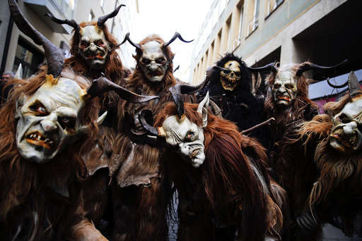 Men dressed as 'Krampuss' prepare to parade at Munich's Christmas market