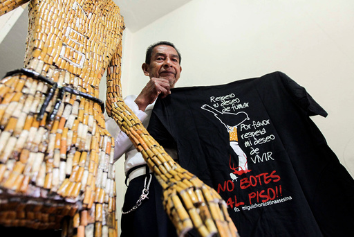 Ecuadorean Miguel Andagana shows puppets made of cigarette butts at his home in Puerto Ayora