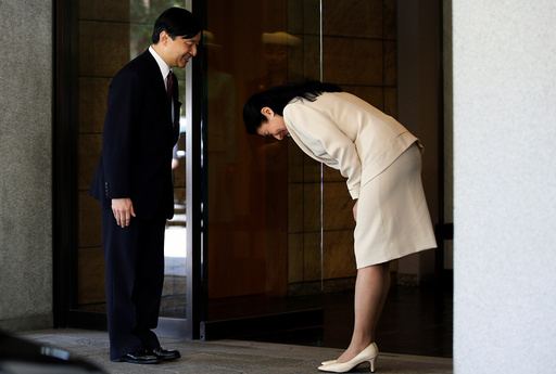 Japan's Crown Princess Masako bows to her husband Crown Prince Naruhito before he leaves for Malaysia at Togu Palace in Tokyo