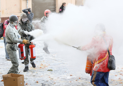 Revellers battle with flour and eggs during the traditional Els Enfarinats (The Floured) festival in Ibi