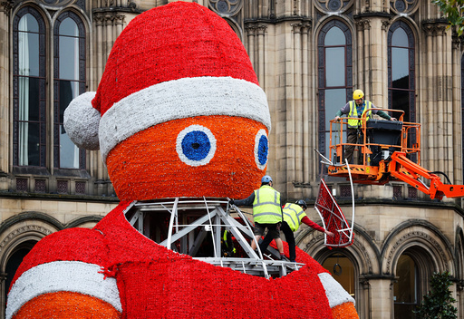 Workers install a giant Santa Claus figure in Manchester