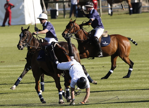 Britain's Prince Harry falls from his horse during the Sentebale Royal Salute Polo Cup in Paarl