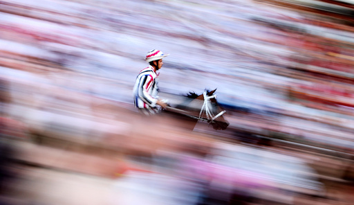 Jockey Elias Mannucci of Istrice (Porcupine) parish rides his horse during the first practice for the Palio horse race in Siena