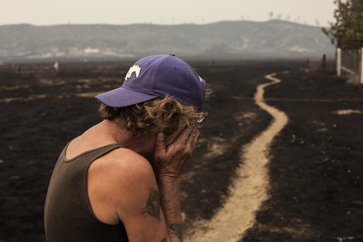 Robert Hooper, exhausted after several days with little sleep, is overcome with emotion while surveying his property that was burnt by the so-called Valley Fire near Middleton, California