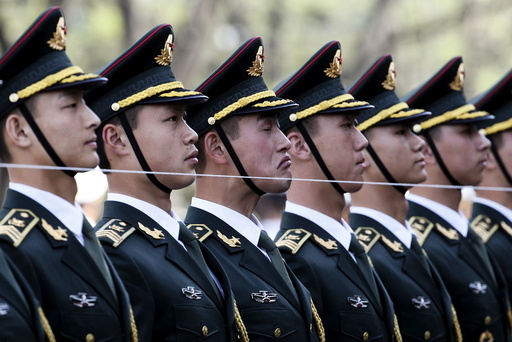 Members of a Chinese People's Liberation Army (PLA) honour guard stand behind a string to ensure that they are in a straight line before a welcoming ceremony for Swiss President Johann Schneider-Ammann at the Great Hall of the People in Beijing