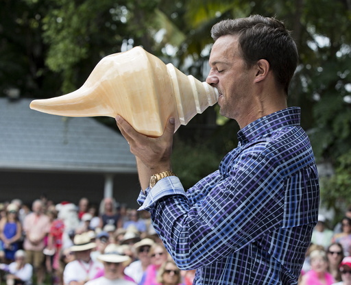 Handout of Fritz blowing a huge shell during the Annual Conch Shell Blowing Contest in Key West