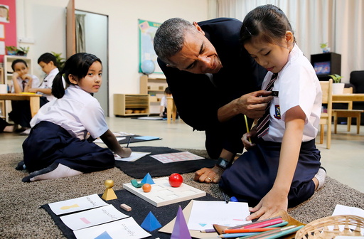 U.S. President Barack Obama learns a girl's name as he greets students on a tour of the Dignity for Children Foundation, in Kuala Lumpur, Malaysia