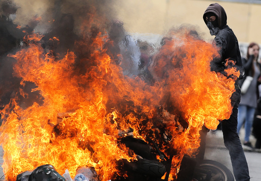 Protestors surround a burning scooter during a demonstration against French labour law reform in Nantes