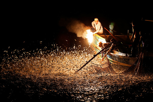 The Wider Image: Fishing with fire