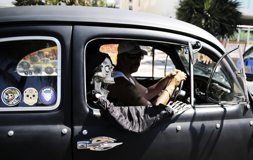 A resident drives his Volkswagen Fusca during the Fusca National Day near Ipanema beach in Rio de Janeiro