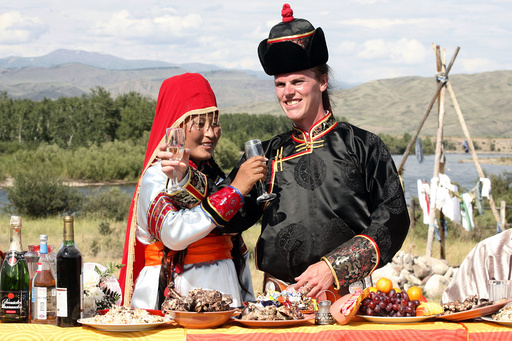 Quirk, of U.S., and his bride Ondar toast champagne during their wedding ceremony outside the city of Kyzyl, in the Russia's Tuva region