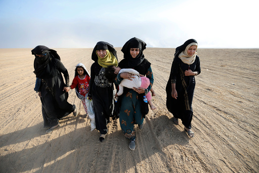 Civilians return to their village after it was liberated from Islamic State militants, south of Mosul