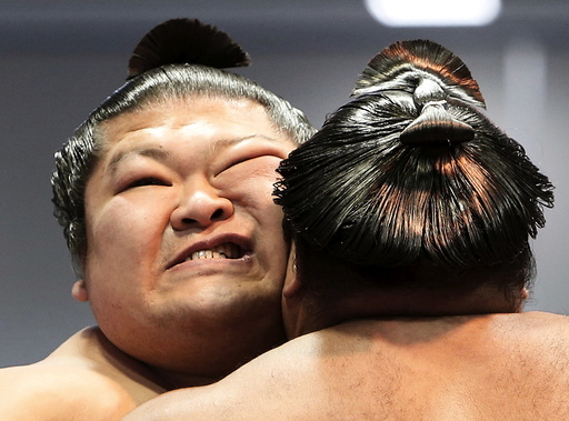 Sumo wrestlers compete during the annual 'Honozumo' ceremonial sumo tournament dedicated to the Yasukuni Shrine in Tokyo, Japan