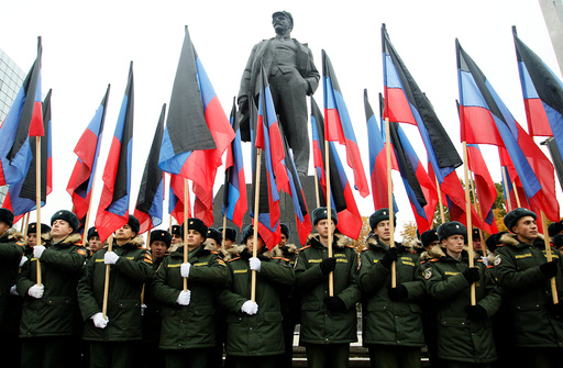 Students of a military school stand in formation in front of a monument to Soviet state founder Vladimir Lenin before the march marking the Day of Flag of the self-proclaimed Donetsk People's Republic in the rebel-controlled city of Donetsk