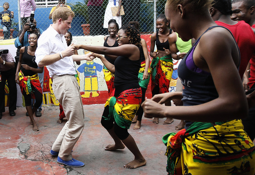 Britain's Prince Harry dances with Dormer at a youth community center in Kingston