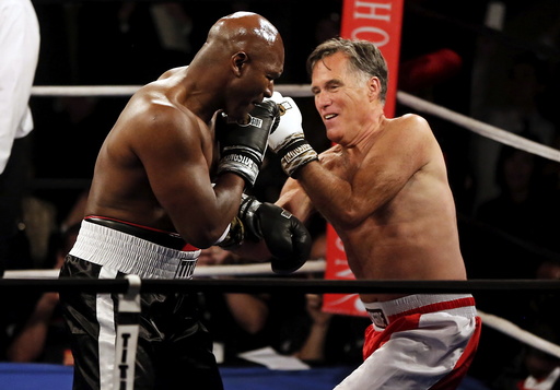 Former Massachusetts Governor and two-time presidential candidate Mitt Romney fights five-time heavyweight champion Evander Holyfield during their boxing match in Salt Lake City, Utah