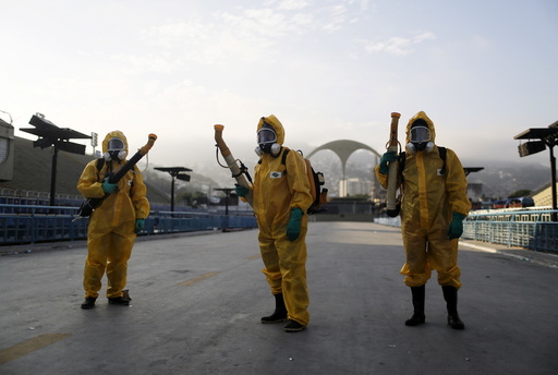 Municipal workers wait before spraying insecticide at Sambodrome in Rio de Janeiro