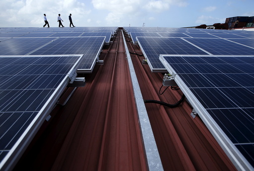 Sun Electric's Chief Executive Officer Matthew Peloso walks along rows of rooftop solar panels operated under the company's SolarSpace energy retail programme at a factory in Singapore
