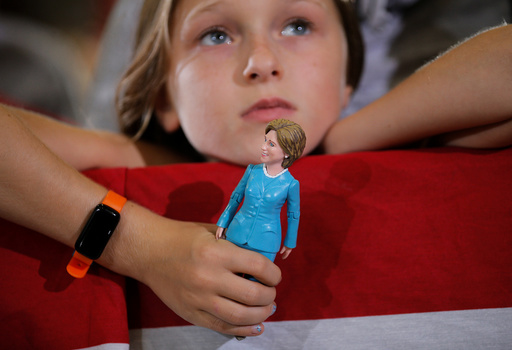 Nine-year-old Belle Shefrin holds a doll of U.S. Democratic presidential nominee Hillary Clinton while listening to Clinton speak at a campaign rally in Akron