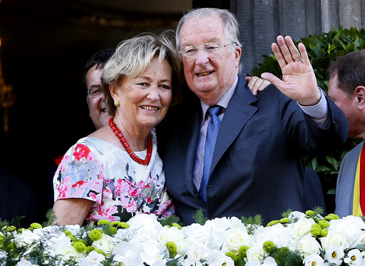 Belgium's King Albert II and Queen Paola wave from the balcony of the city hall during a visit in Liege