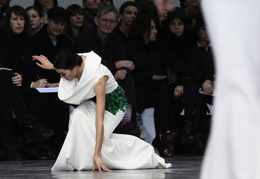 A model falls as she presents a creation by French designer Rolland as part of his Haute Couture Spring-Summer 2013 fashion show in Paris