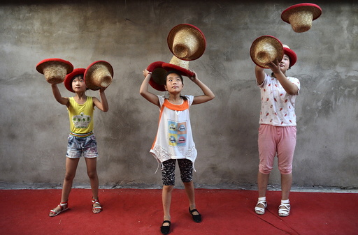 Students toss hats as they practice at an acrobatic school in Sanwang village