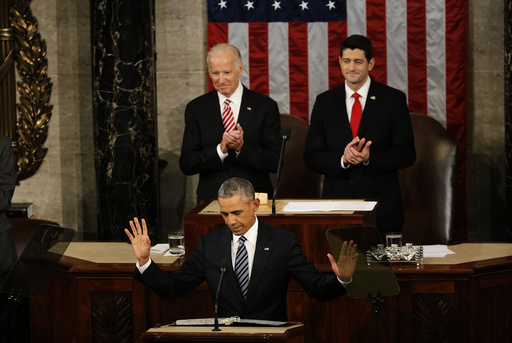 U.S. President Barack Obama reacts to cheers as he arrives at the podium to deliver his State of the Union address to a joint session of Congress in Washington