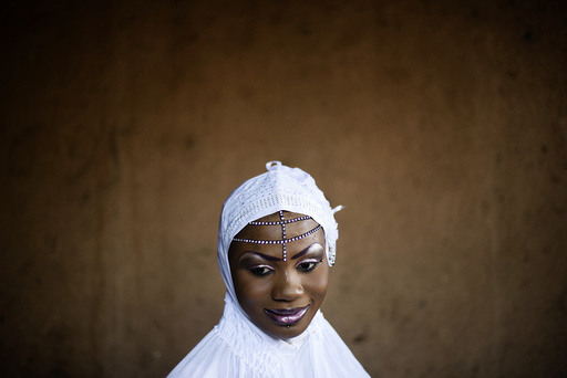 A woman stands as she attends the celebrations before her wedding in the district of Djicoroni, Bamako