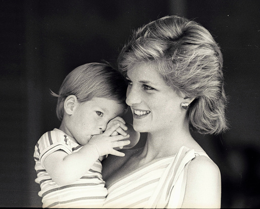 Young Prince Harry tries to hide behind his mother Diana, Princess of Wales