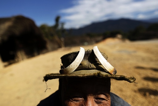 A man who claims to be 100 years old wears a hat adorned with wild boar tusks in Donhe township in the Naga Self-Administered Zone