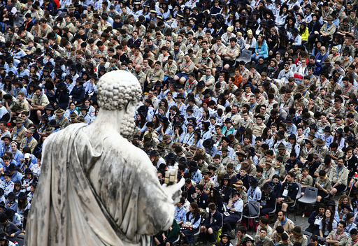 The statue of Saint Peter overlooks the faithful as they attend a mass for the Youth Jubilee led by Pope Francis in Saint Peter's Square at the Vatican