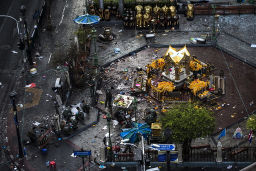 Experts investigate the Erawan shrine at the site of a deadly blast in central Bangkok