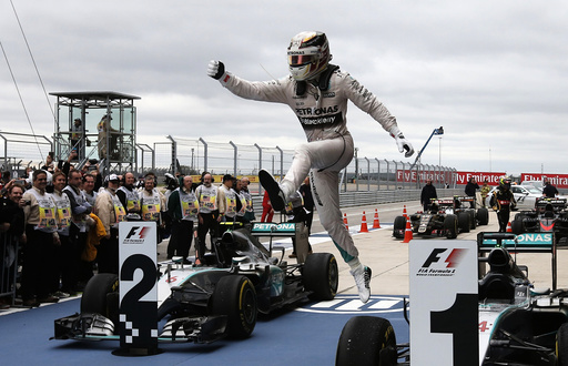 Mercedes Formula One driver Lewis Hamilton of Britain leaps off of his car after winning the U.S. F1 Grand Prix at the Circuit of The Americas in Austin