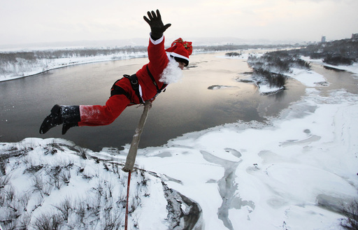 A man dressed as Father Frost, Russian equivalent to Santa Claus, jumps makes a bungee jump from a bridge across the Yenisei River in the Siberian city of Krasnoyarsk
