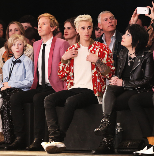 Musicians Beck, Bieber and Jett watch the Saint Laurent fall collection during a fashion show at the Hollywood Palladium in Los Angeles