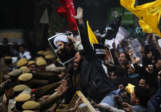 Shi'ite Muslims try to cross a barricade during a protest against the execution of cleric Nimr al-Nimr, who was executed along with others in Saudi Arabia, in front of Saudi Arabia embassy in New Delhi