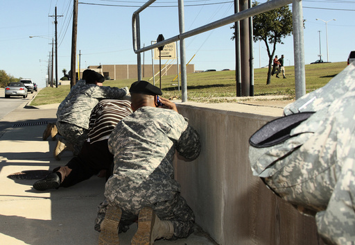 Bystanders crouch for cover as shots rang out from Fort Hood's Soldier Readiness Processing Center