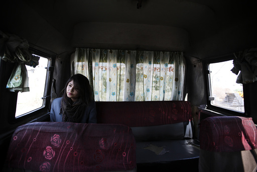 A woman rides a women-only bus as she returns from her college in Kathmandu