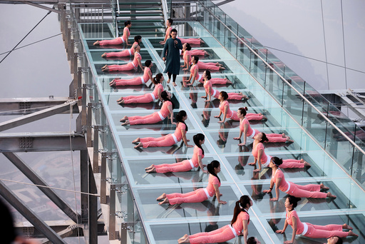 People practise yoga at a tourist spot ahead of the International Day of Yoga, on the outskirts of Beijing