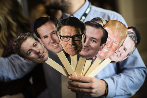 A man interviewing attendees holds photo cutouts of 2016 presidential hopefuls at the Conservative Political Action Conference.