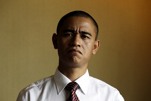 Xiao Jiguo, a 29-year-old actor from China's Sichuan province, impersonates U.S. President Barack Obama, in a hotel room in the southern Chinese city of Guangzhou