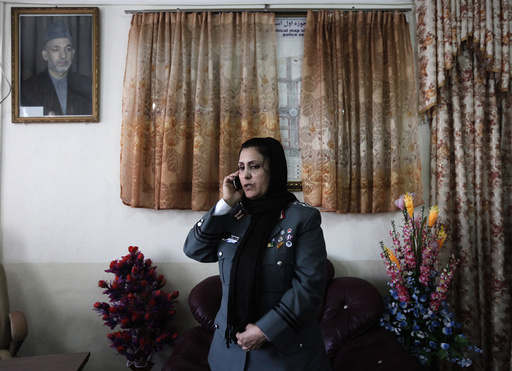 Colonel Bayaaz talks on the phone at her office before an interview in Kabul