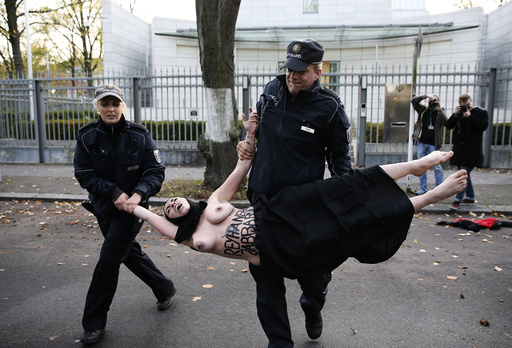 Police detain activist of women's rights group Femen during protest outside the Iranian embassy in Berlin