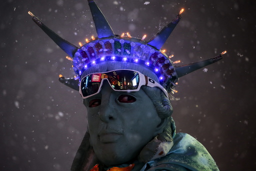 A man is seen posing as the Statue of Liberty during a snow storm in Times Square in the Manhattan borough of New York