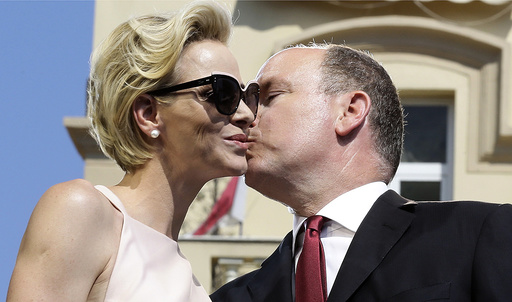Prince Albert II of Monaco and his wife Princess Charlene embrace during the celebration of the 10th anniversary of the Prince's accession to the throne in Monaco